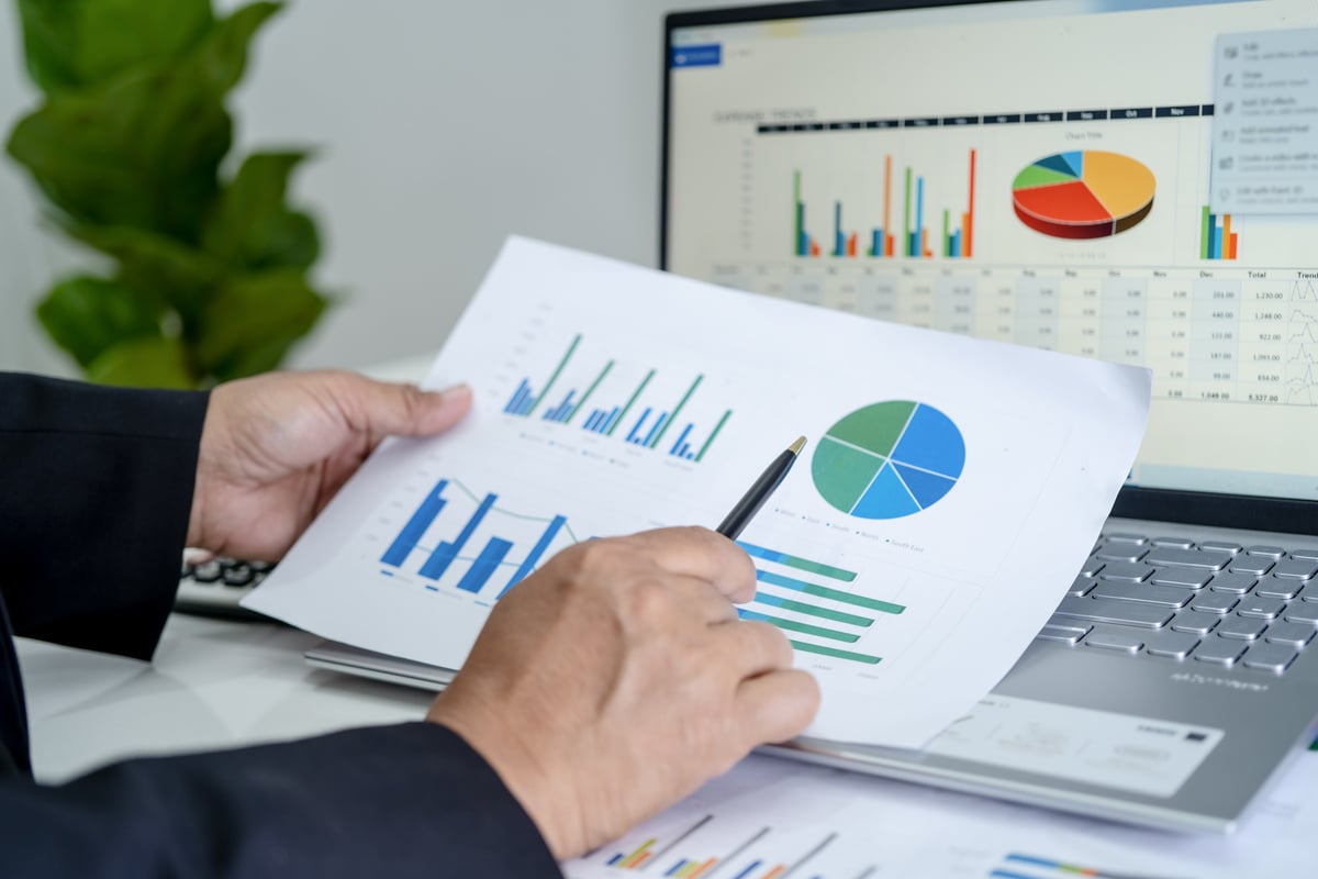 Asian Accountant Working and Analyzing Financial Reports Project